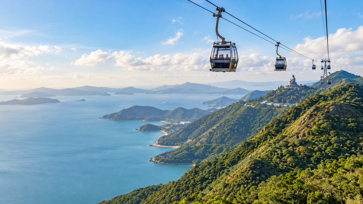 Cable cars over the mountains of Lantau Island, with the Big Buddha in the distance